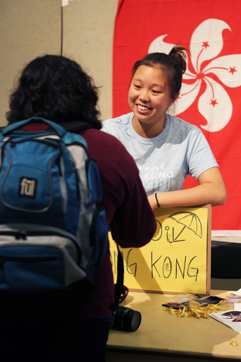 Tiffany Chung '17 explains the movement in Hong Kong and hands out yellow ribbons to raise awareness in the Pendleton entrance. 