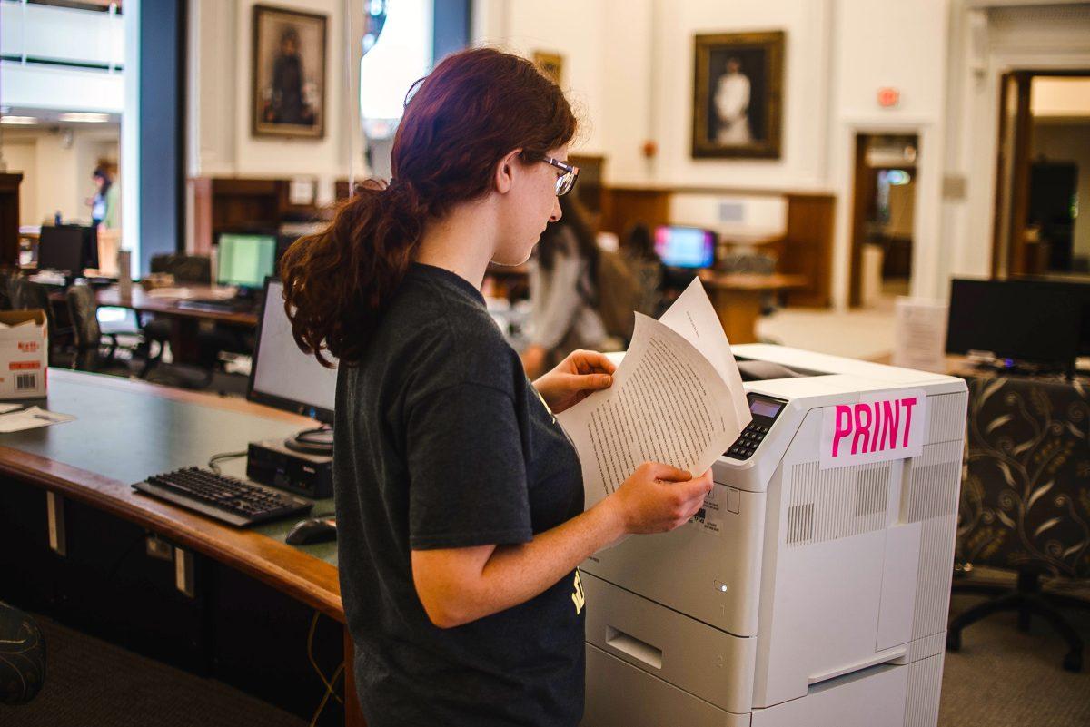 A Wellesley student uses a new HP Clapp Library printer. 