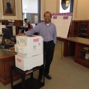 LTS Chief Information Officer Ravi Ravishanker poses near a new printer. 