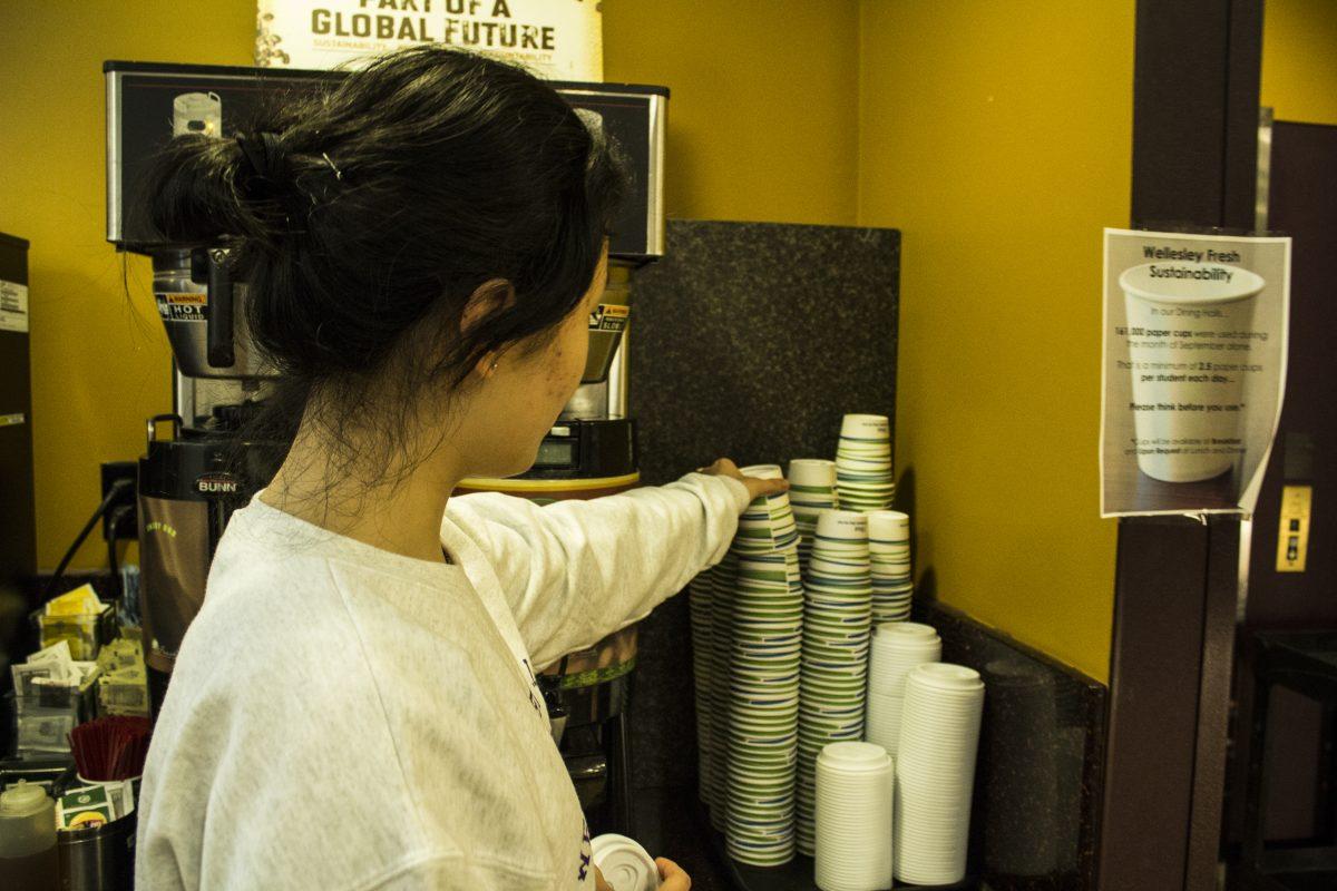 A Wellesley student fetches a paper cup in Bates Dining Hall | Photo by Megan Stormberg '18, Photography Editor