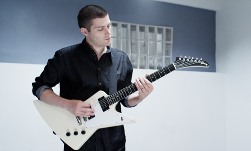 Andre Allan Anjos playing guitar in his music video 