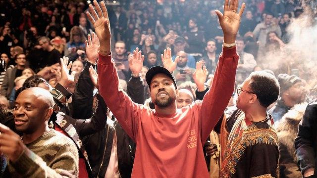 Kanye West raises his hands to his music while at “Yeezy Season 3” in Madison Square Garden. Photo courtesy of Dimitrios Kambouris/Getty images