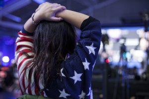 A patriotically dressed sibling eagerly watches election result. Photo by Audrey Stevens '17, Photo Editor.