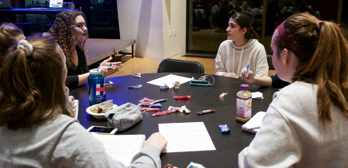 Zainab Younus ’17 conversing with senators. | Photo by Kat Tyson '20, Staff Photographer.