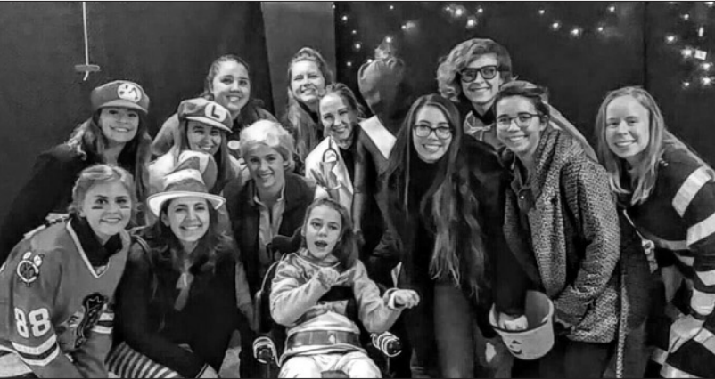 Each year, the softball team goes trick-or-treating with Maeve Flack, a recipient of
VocaliD’s customized voices. | Photo courtesy of Sydney Hopper '19.