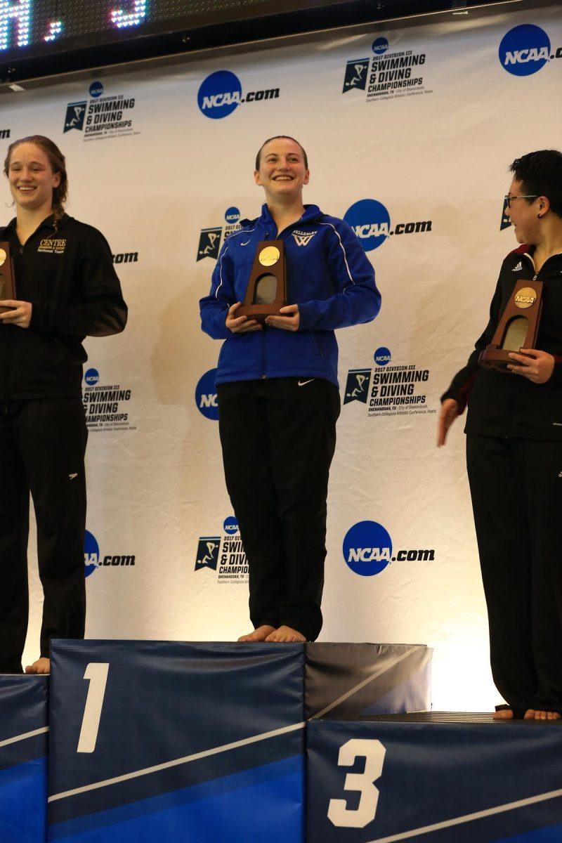 Maura Sticco-Ivins accepts trophy for her National Championship
in the one-meter dive on Friday March 17 in
Shenandoah, Texas. | Photo courtesy of Wellesley Blue / D3Photography.com