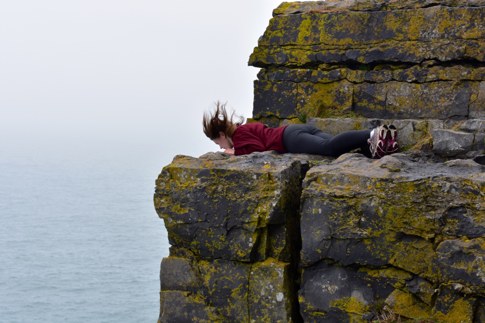 Hauke lies down on a cliff near the Aran Islands Photo Courtesy of ’19