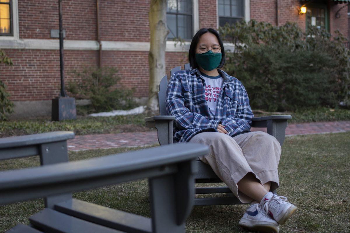 Joy Li ’23 sits outside Cazenove Hall, where she has lived nine of the past twelve months

(Photo by Macy Lipkin)