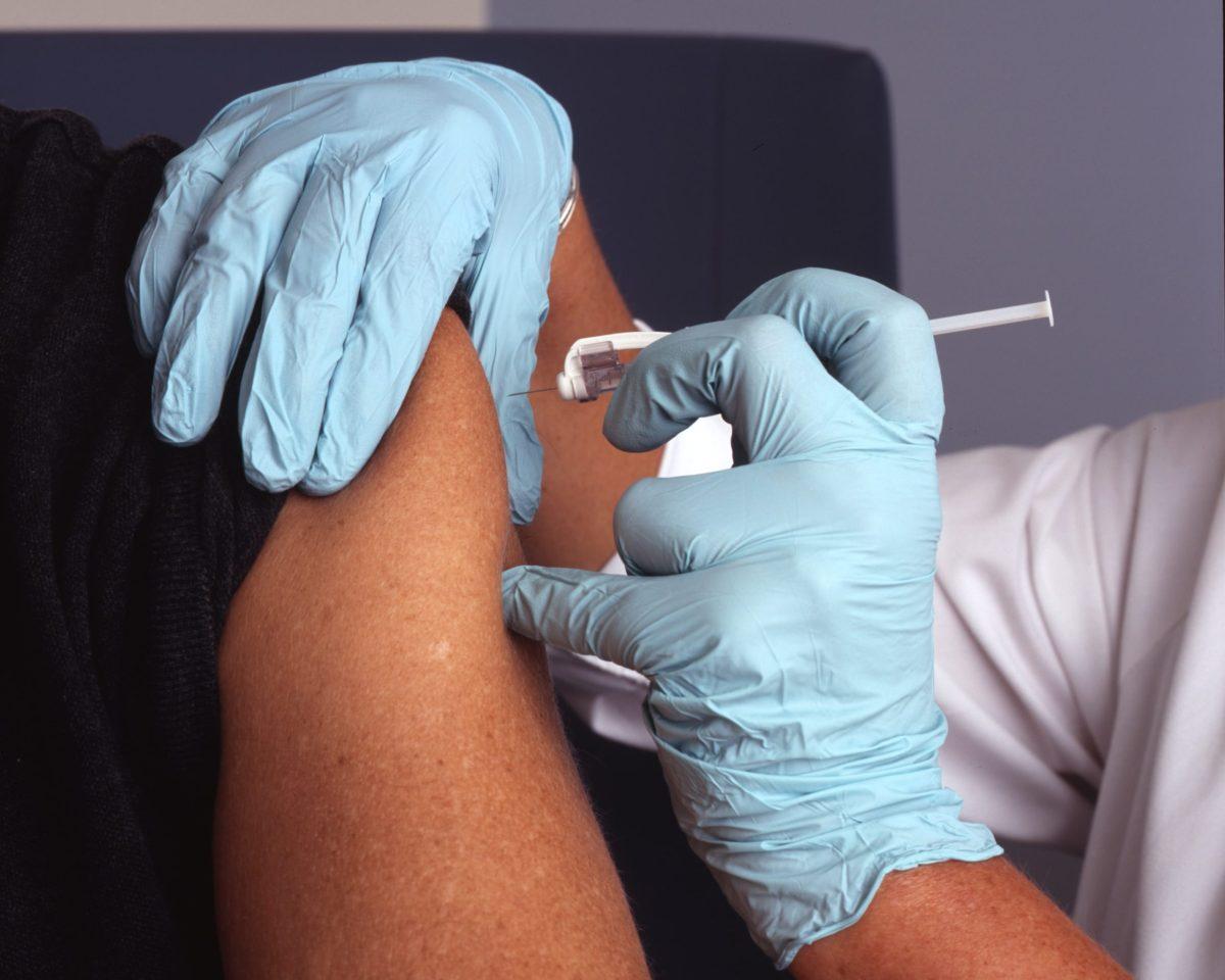 A patient receives a COVID-19 vaccine. Photo courtesy of the National Cancer Institute on Unsplash