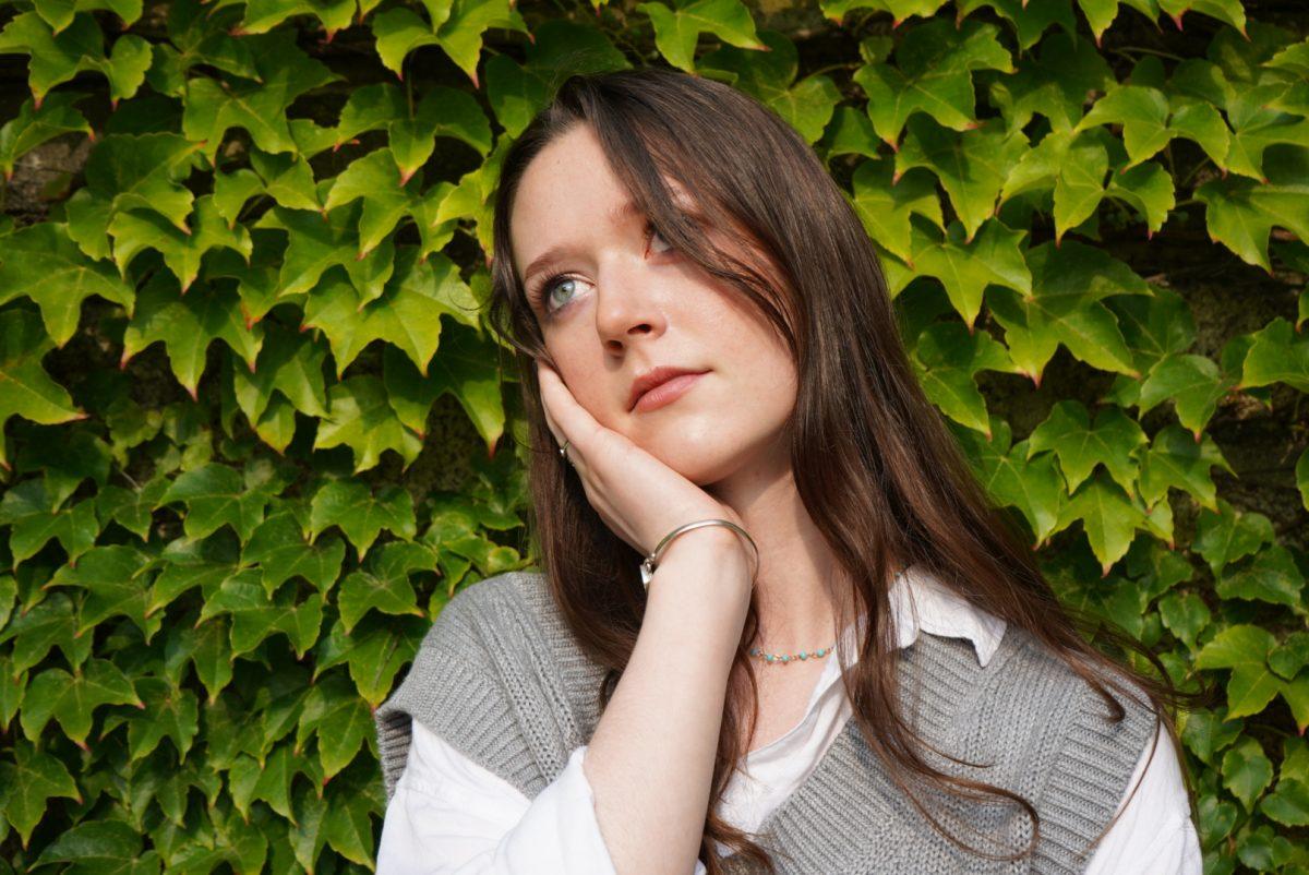 image of Isabel Pless '22 in front of leaves