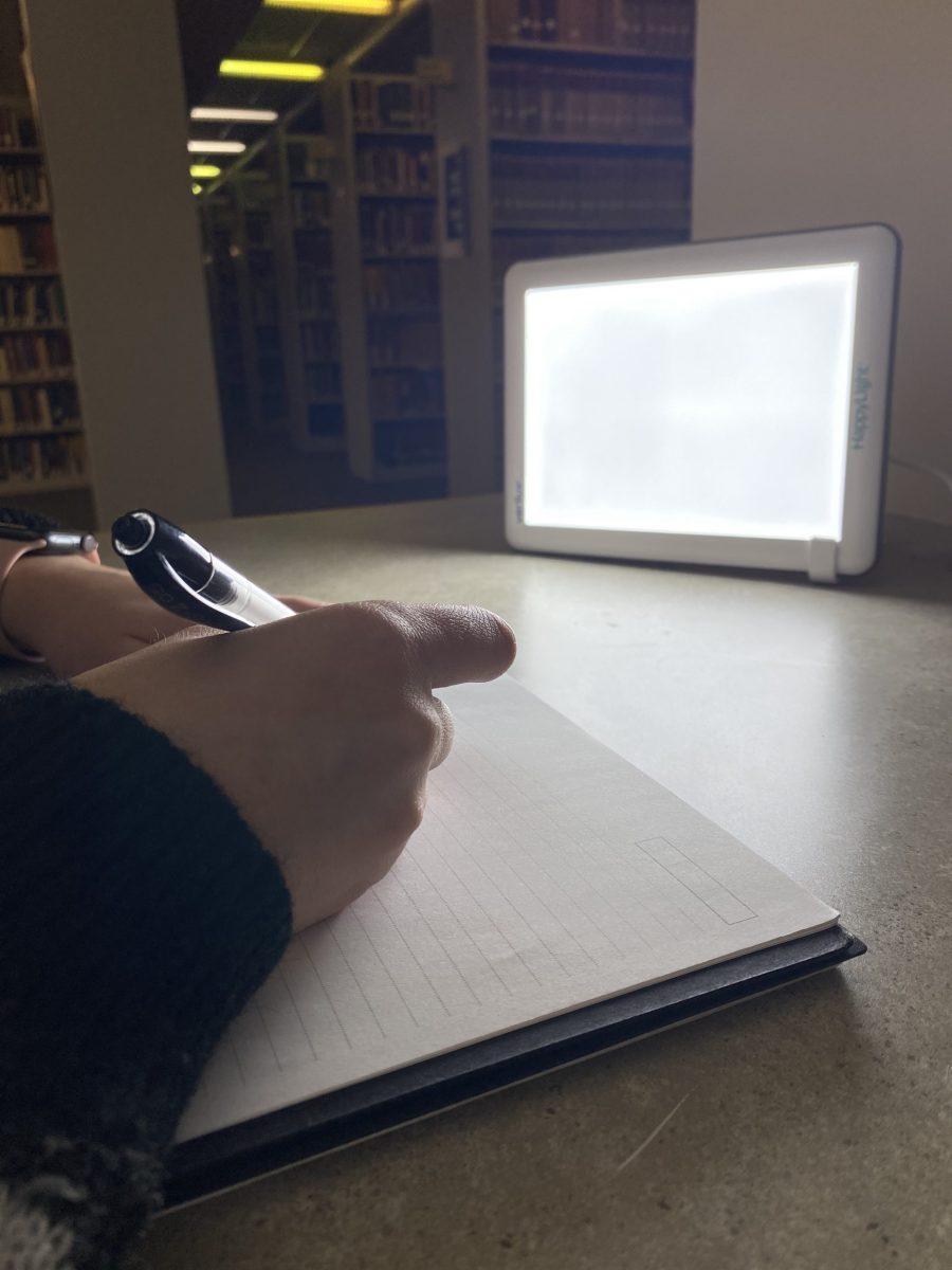 A student uses a sun lamp to combat SAD as winter enters full force. Photo courtesy of Andreea Sabau and Toshali Goel