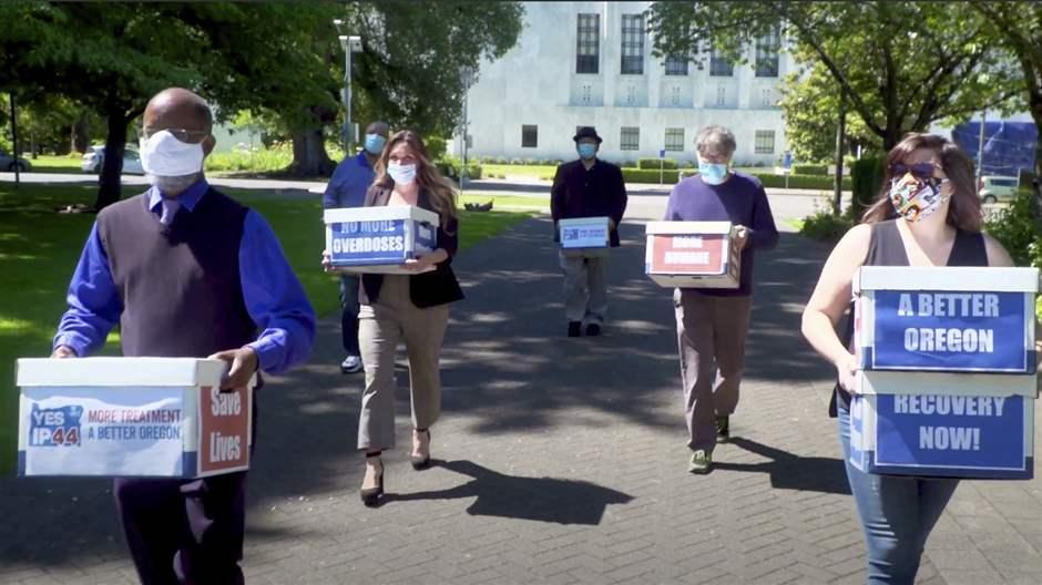 Volunteers deliver boxes of signed petitions in favor of decriminalizing drugs. Photo courtesy of Associated Press