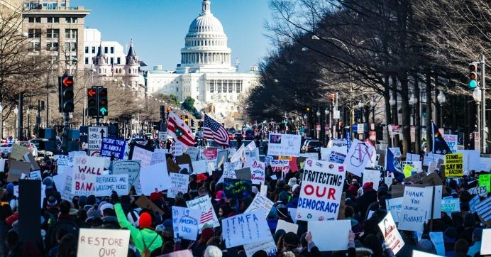 Protestors holding signs outside of White House