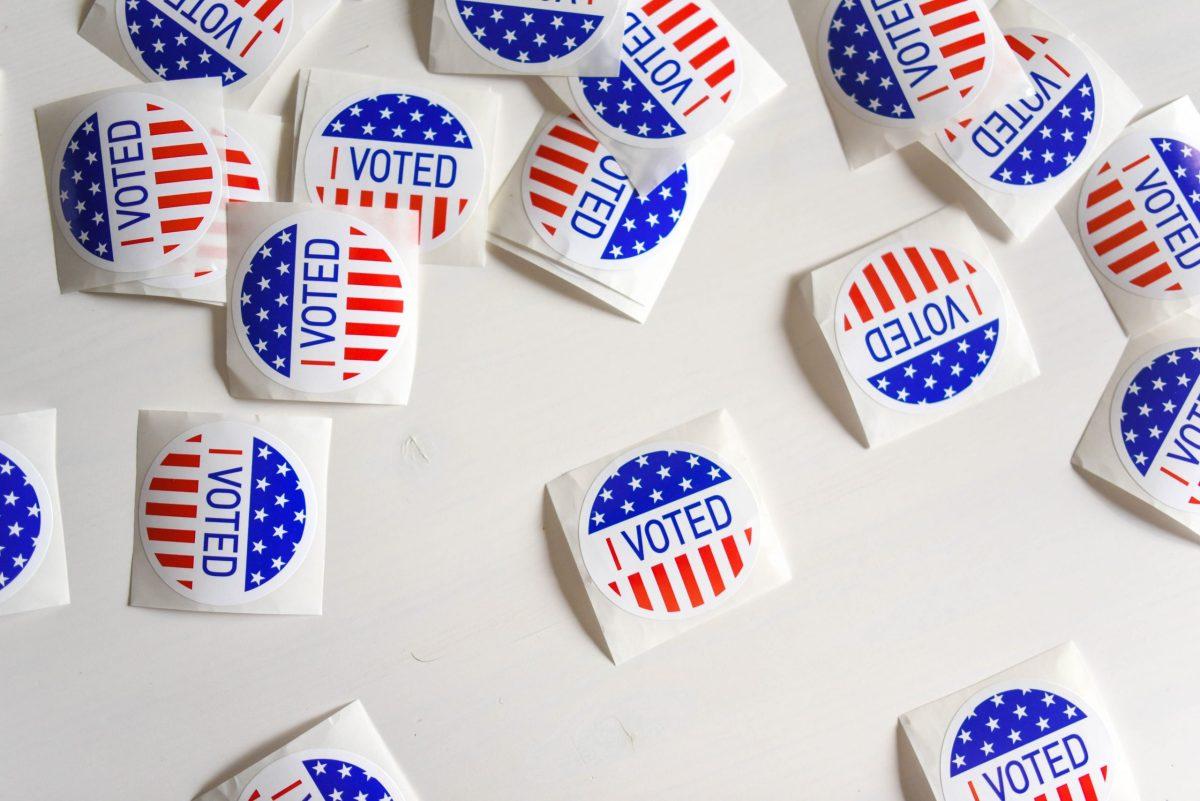 Image shows many "I Voted" stickers on a white background