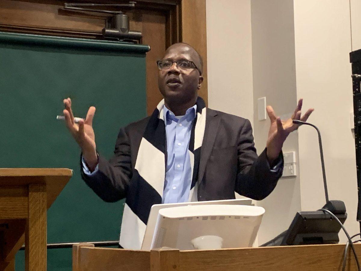 Professor Mbaye Lo presents during his lecture discussing his recent book. Photo Courtesy of India Lacey. 