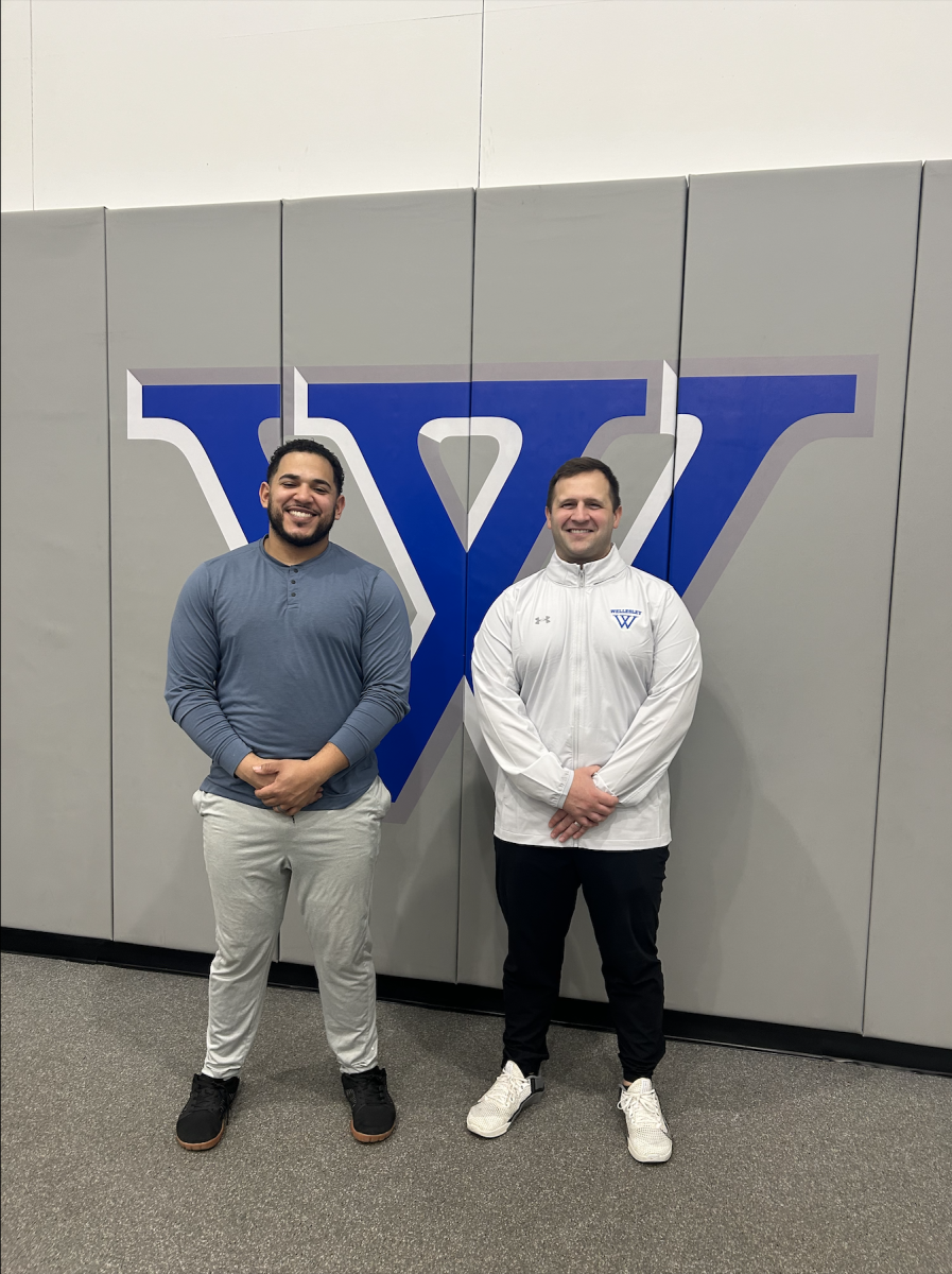 Caption: Nico Santiago (left) and Tim Snyder (right) in the Wellesley varsity weight room.