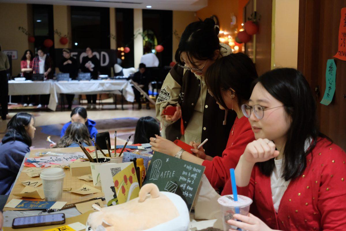 Vendors at the Night Market work the raffle booth. 
Photo Courtesy of Olivia Hewang. 