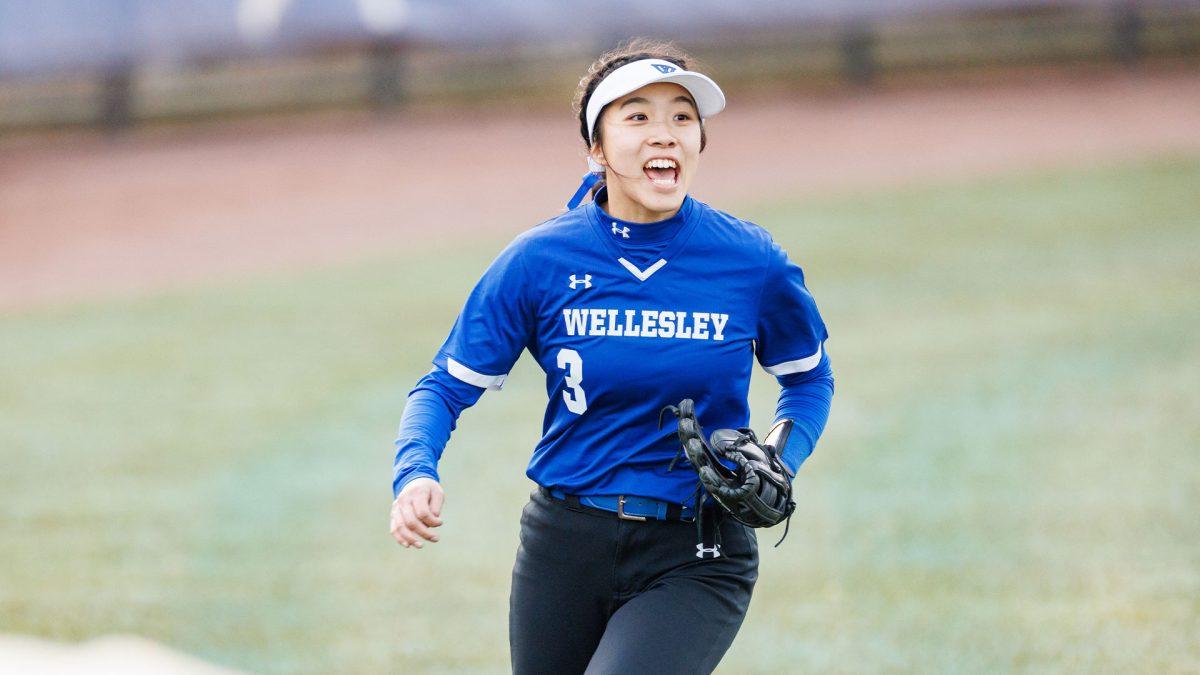 A Wellesley softball player celebrates a catch.